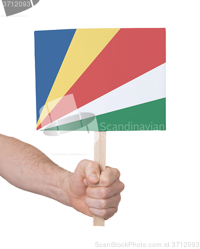 Image of Hand holding small card - Flag of Seychelles