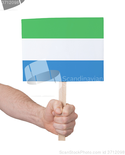 Image of Hand holding small card - Flag of Sierra Leone