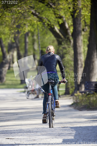 Image of Woman on the bicycle in park