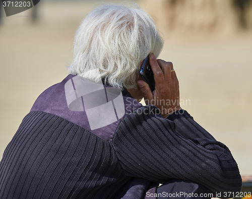 Image of Senior man speaking on smartphone