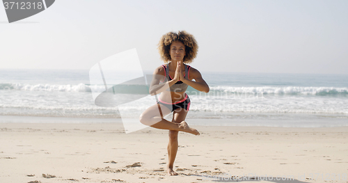 Image of Woman Is Doing Yoga On The Beach