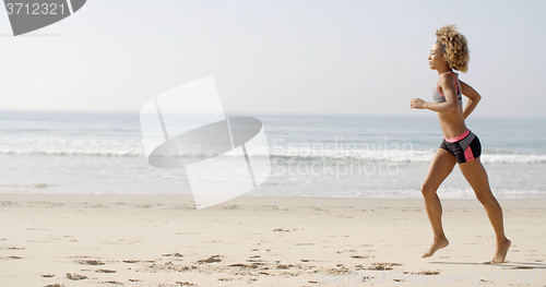 Image of Woman Running On The Beach