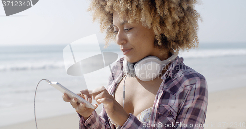 Image of Girl On Beach Listening To Music