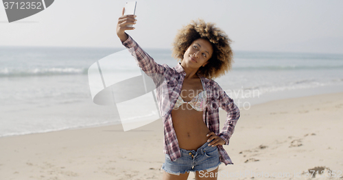 Image of Woman Posing To Take A Selfie On The Beach