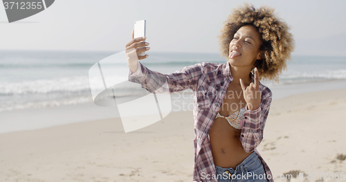 Image of Young Woman Doing Selfie On The Beach