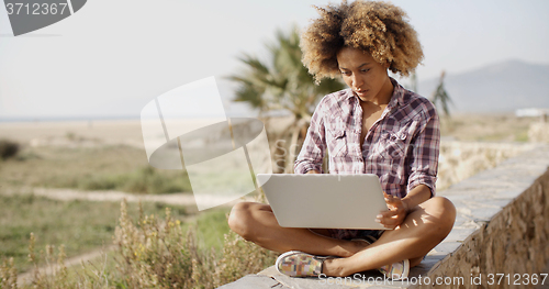 Image of Girl Working With A Laptop Outdoors
