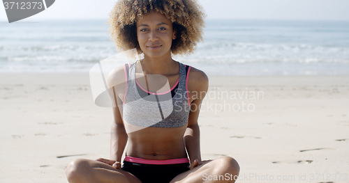 Image of Fit Woman Sits On The Beach