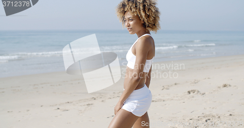 Image of Young Woman Walking On The Beach In Summer