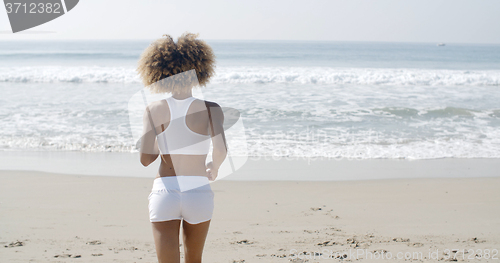 Image of Woman Jogging On The Beach