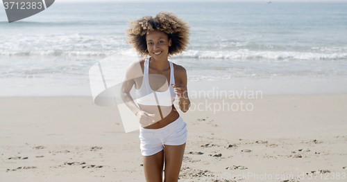 Image of Woman Jogging On The Beach