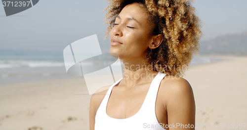 Image of Young Woman Enjoying Sunlight.