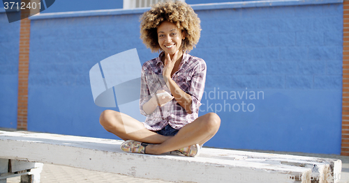 Image of Female Using Mobile Phone On A Road