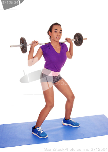 Image of African American woman weight lifting.