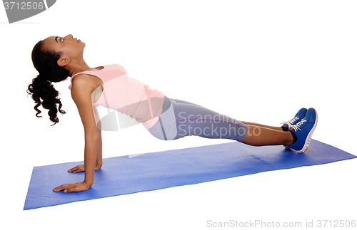 Image of Beautiful African American woman exercising.