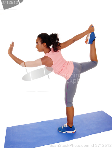 Image of Beautiful African American woman stretching her body.