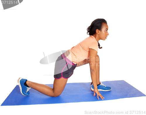 Image of Young African American woman exercising.