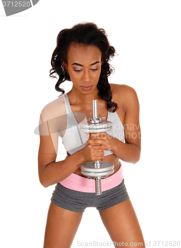 Image of African American woman with dumbbell\'s.