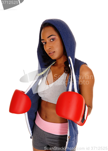 Image of African woman in hoodie and red boxing cloves.