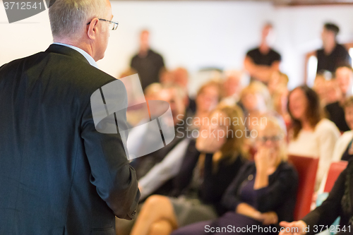 Image of Speaker at Business Conference and Presentation.