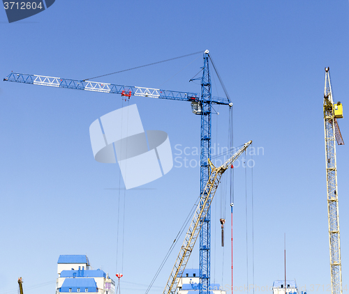 Image of Industrial landscape with silhouettes of cranes on the sky backg