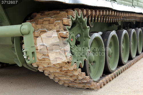 Image of Part of the undercarriage of tracked military equipment, close-up