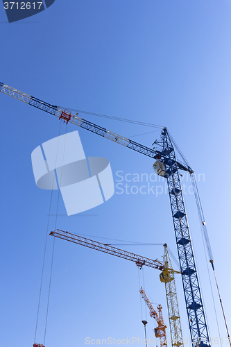 Image of Industrial landscape, building crane against the blue sky