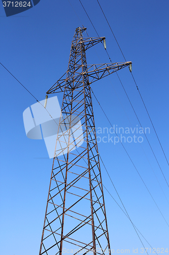 Image of High voltage power pylons against blue sky