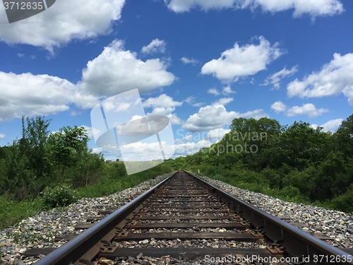 Image of Railway to horizon and clouds on the sky background.