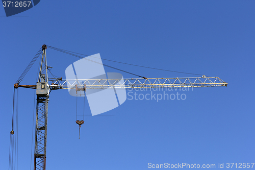 Image of Industrial landscape, building crane against the blue sky