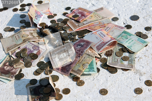 Image of Pile of money notes and coins of different countries