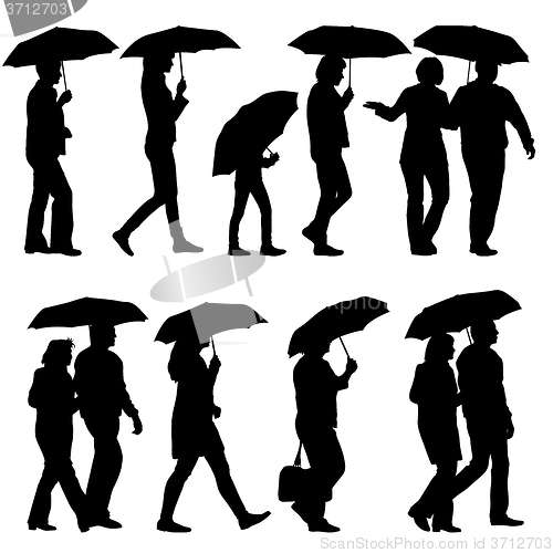 Image of Black silhouettes man and woman under umbrella. 