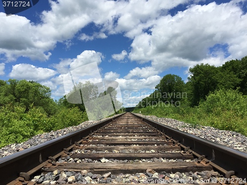 Image of Railway to horizon and clouds on the sky background.