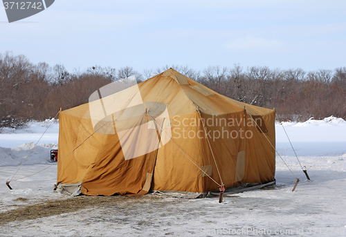 Image of Military khaki tent in the snow polar region in a forest