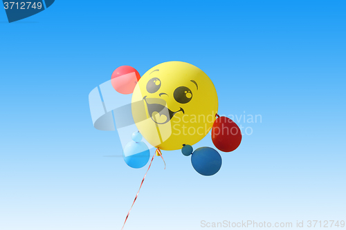 Image of Yellow balloon flying on a blue sky background