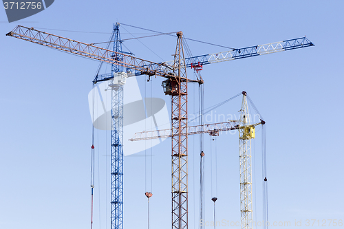Image of Industrial landscape with silhouettes of cranes on the sky backg