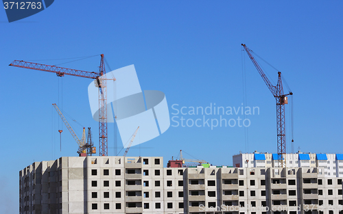 Image of Industrial landscape with silhouettes of cranes on the sky backg