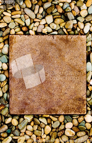 Image of Stone slab surrounded by grungy pebbles

