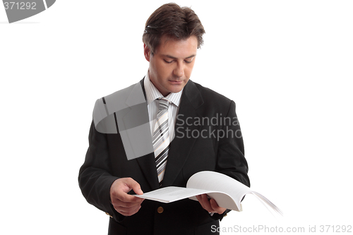 Image of Businessman reading report or document