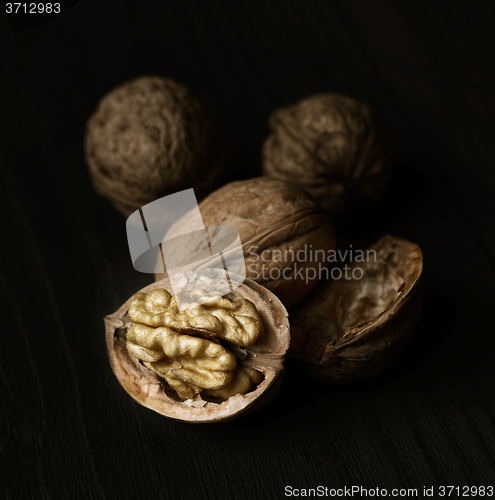 Image of Walnuts on rustic old wooden table