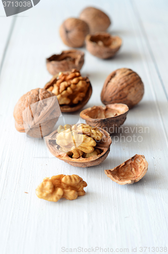 Image of Walnuts on rustic old wooden table