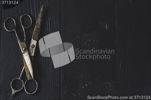 Image of Old scissors on wooden background