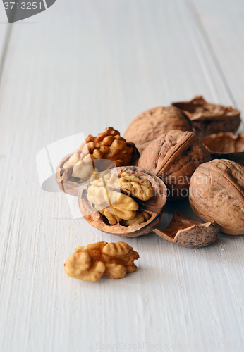 Image of Walnuts on rustic old wooden table