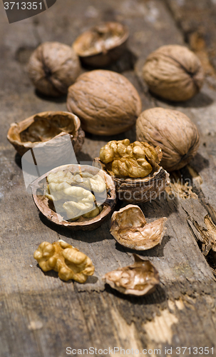 Image of Walnuts on rustic old wooden table