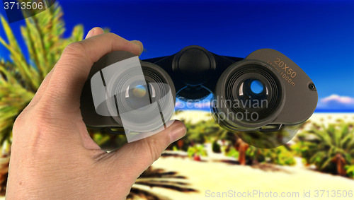 Image of Man scouring area through his binoculars 