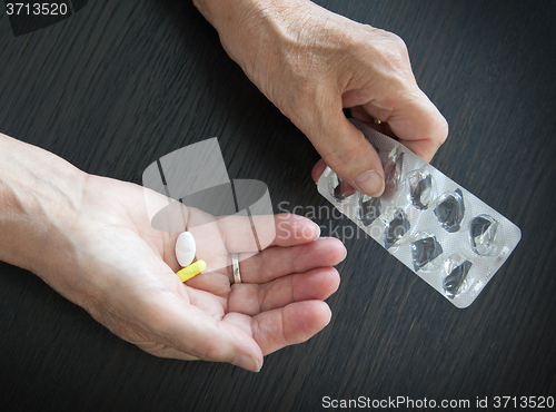 Image of Elderly person taking medication