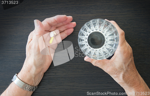 Image of Elderly person taking medication