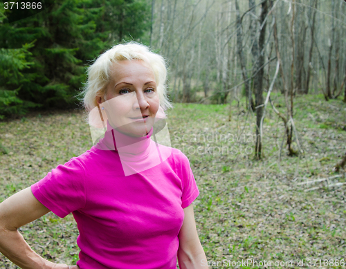 Image of Portrait of a  woman in a park on a sunny day