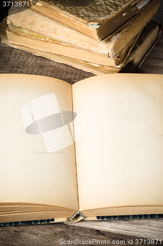 Image of open old book on a wooden surface 