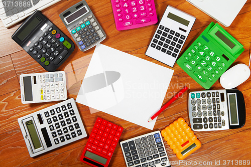 Image of Calculators lying on the wooden flooring