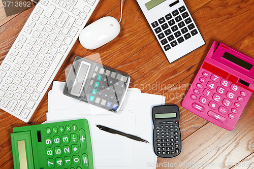 Image of Calculators lying on the wooden flooring